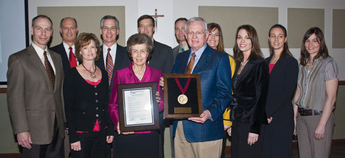 John and Marilyn Dugan at the Cardinal Newman Banquet surrounded by their family