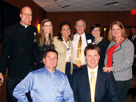 Father Ned Blick ‘86, far left, received the Beata Netemeyer Alumni Award. With Blick at a reception following the ceremony are, l-r, back row: Jackie (Meyer) Cleary ’89; Newman Director of Alumni Relations Sarah (Kriwiel) Cundiff ’86, ‘90; Tim Brady ’87; Tina (Mesa) Walterscheid ’88, and Joan (Hartman) Lipp ‘88; front row: Tom Davis ’88 and Jeff Lipp ’88.
