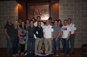Among the wrestlers, spouses and friends who returned to Newman for the Wrestling Program 10-year celebration were, l-r, front row: Chelsea Helena; Veronica Wall; Isaac Wall ‘09; Assistant Wrestling Coach Mitch Arnold ‘13; Assistant Wrestling Coach Blake Fisher ‘11; Greg Delk; Zach Vann; back row: Brett Jenlink ‘08; Lorenzo Serna ‘14; Ryan Spencer; Steven Cooksley ‘14; Tyler Hasenbank ‘13; Amanda Harrison, Head Wrestling Coach Ryan Smith.