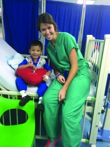 Newman student Blair Benton with child in Ecuador.