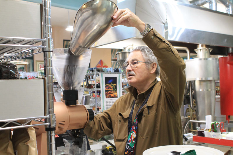 Robert "Bob" Boewe packaging coffee at The Spice Merchant.