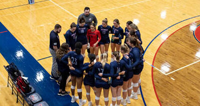 The women's volleyball team huddling up