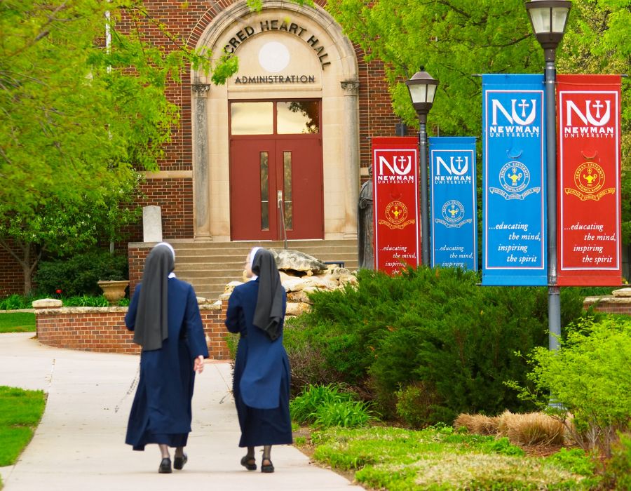 Sisters walk toward Sacred Heart Hall on the Newman University campus.