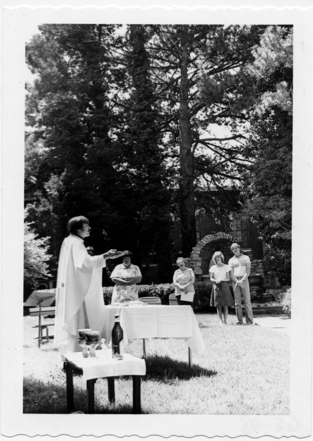 Father Tom Welk offers Mass to students, faculty and staff near the Marian Grotto just outside of Sacred Heart Hall.
