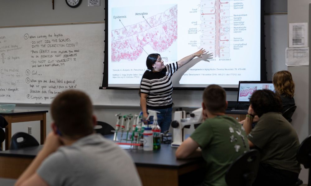 A science professor shares research on "neurogenesis in aging hydra" with students.