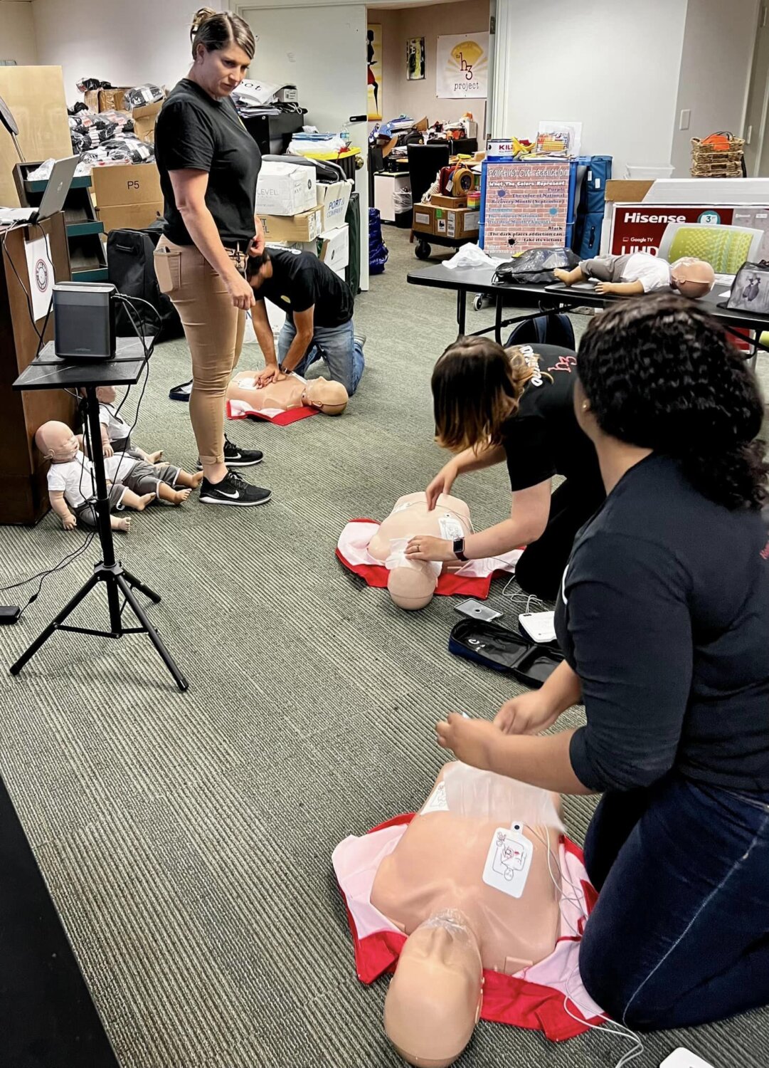 Angell teaches CPR/First AID/AED during a training session through The h3 Project.