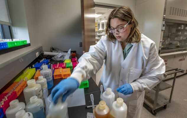 A student works in a lab setting in the Bishop Gerber Science Center.
