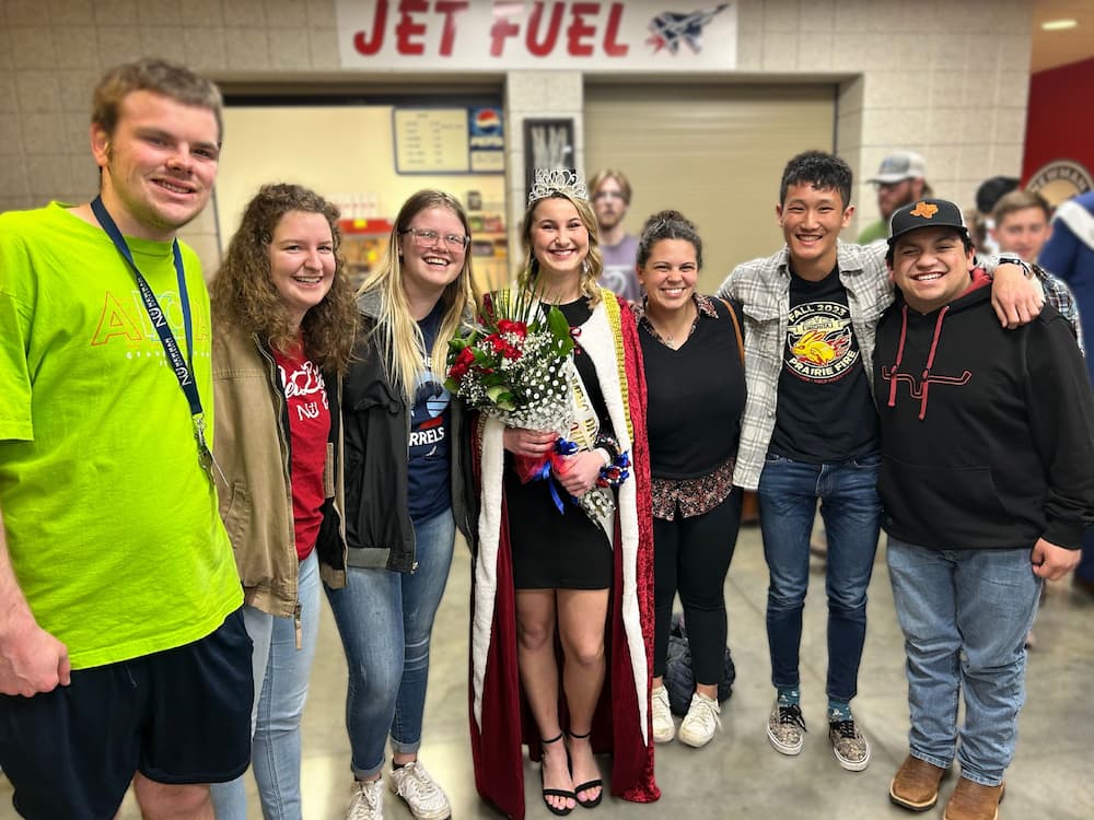 Students of Metanoia celebrate Elise Helfrich's homecoming win.