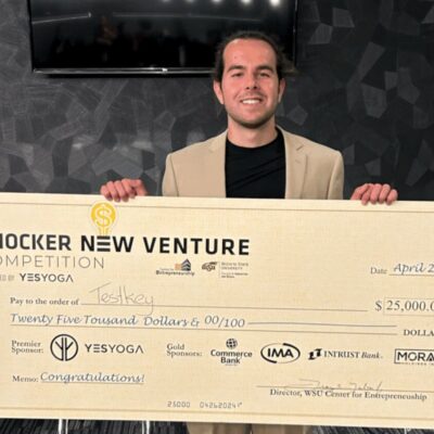 Nick Vasilescu holds up his winning check for Testkey.