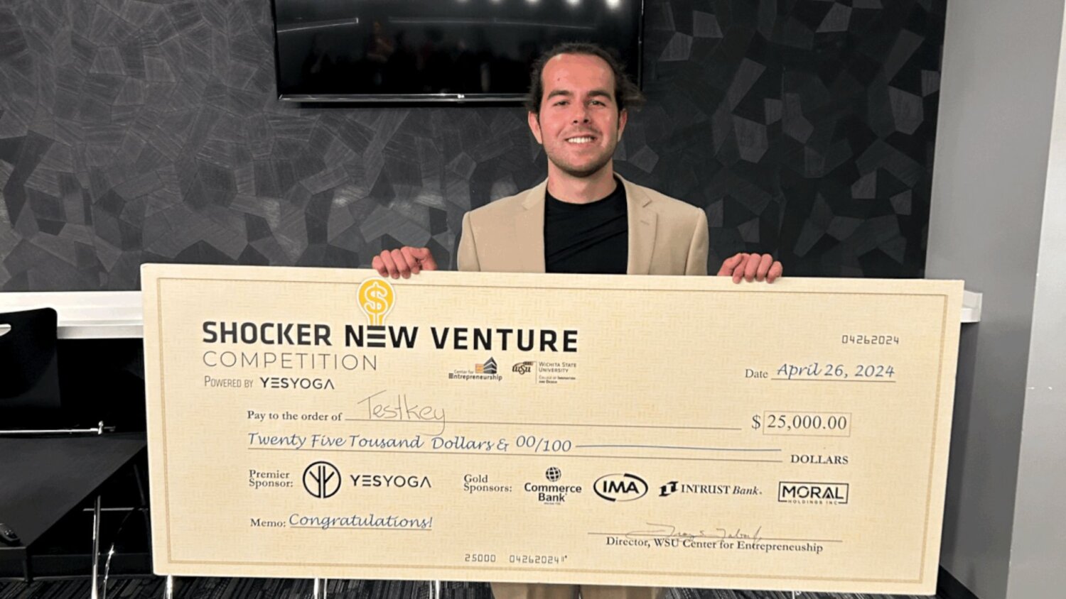 Nick Vasilescu holds up his winning check for Testkey.