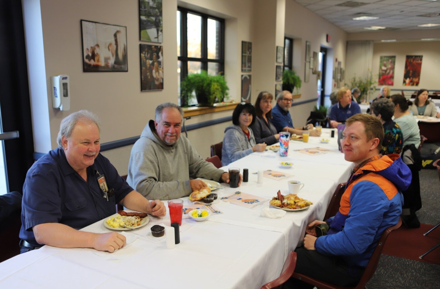 Scott Stardy (left) and fellow Newman employees attend the annual Newman Prayer Breakfast.