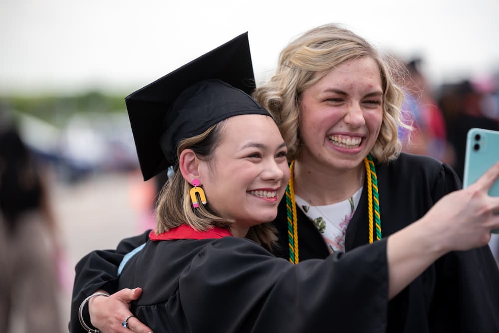 Education graduate Catherine Madison and biology graduate Hope Strickbine