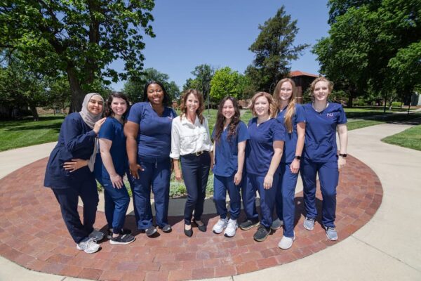 Ewing (center) is surrounded by radiologic technology students of the Newman class of 2024. This group completed their clinicals at the Ascension Via Christi St. Francis Hospital.