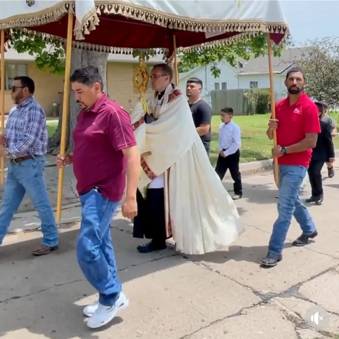 Samsel (center) leads an outdoor Eucharistic procession.