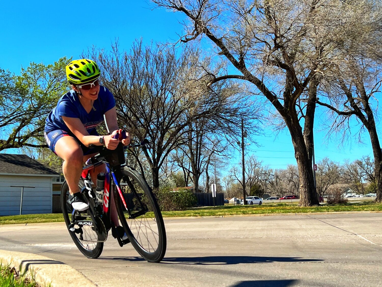 Holmes rounds the corner on a bike during triathlon practice at Newman University.