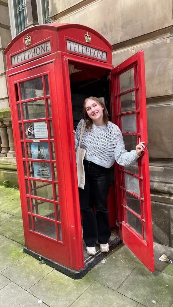 Stewart in a phone booth abroad.